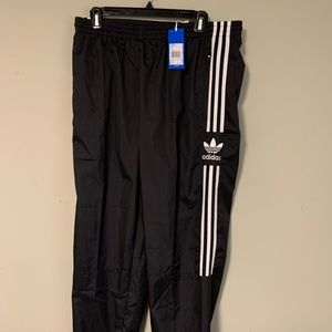 Black with three stripes adidas track pants